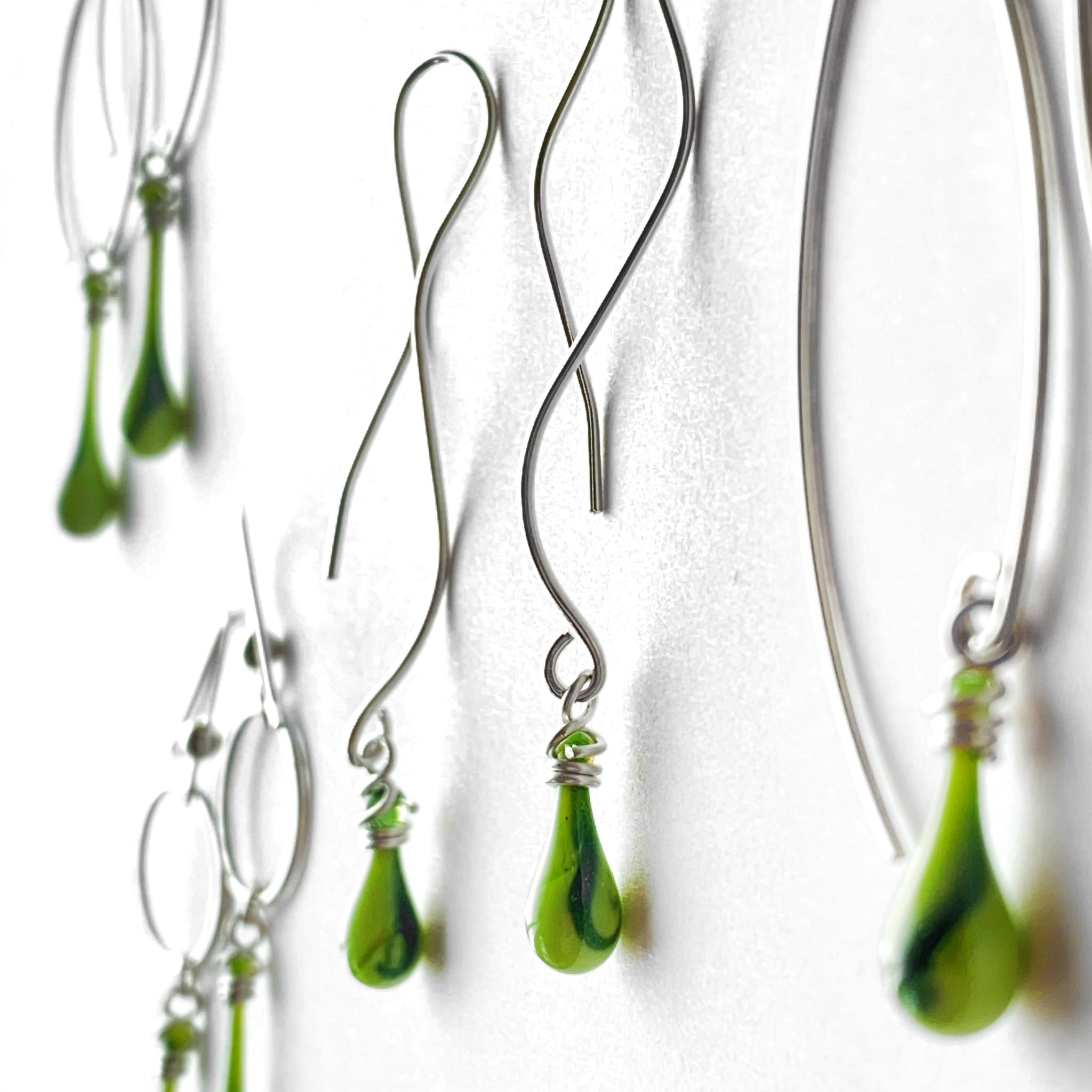 Striking lime green glass earrings with a streak of dark green with glitter!